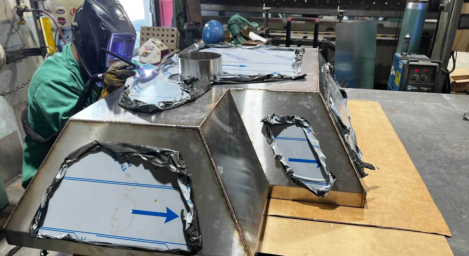 Welder fabricating a custom stainless steel hood