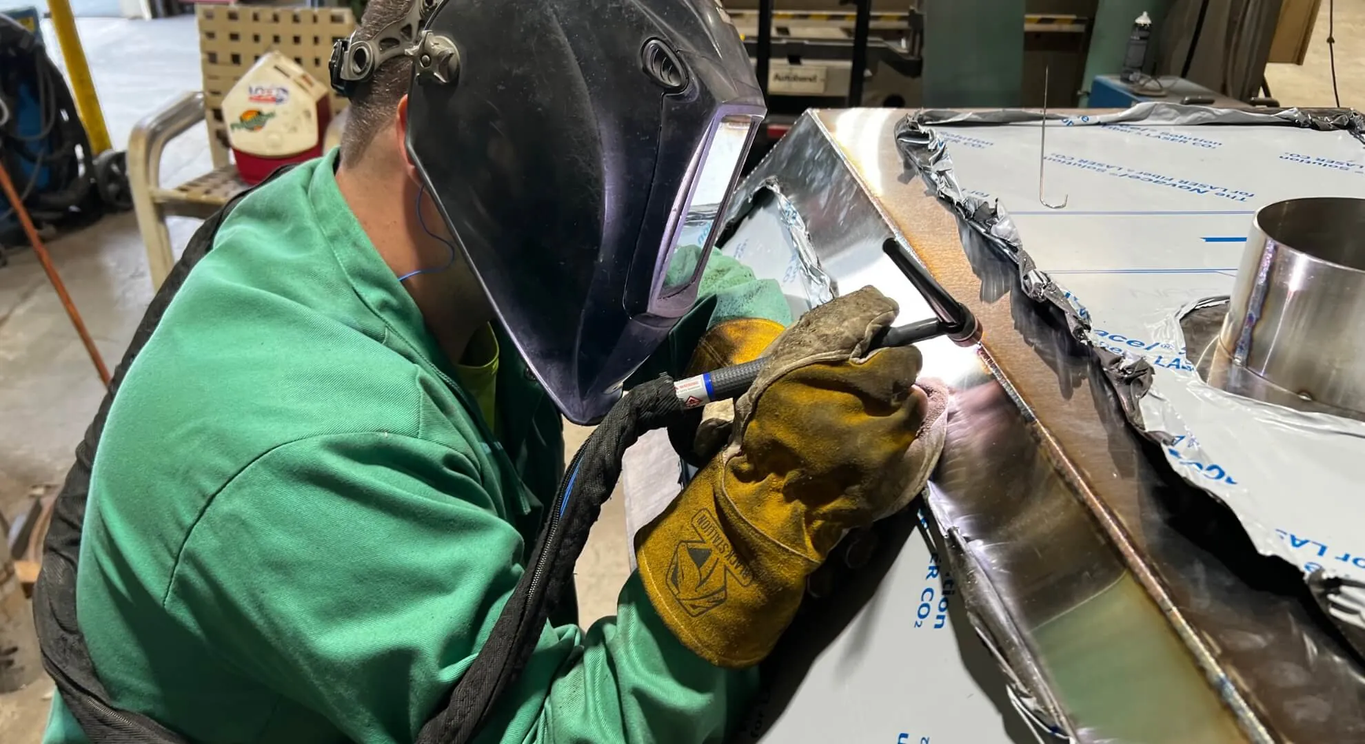 man welding hood vent